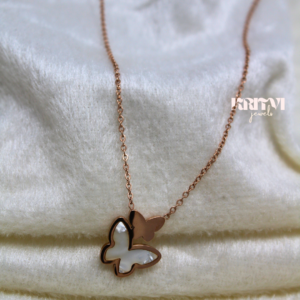 Rose gold-toned necklace featuring a butterfly pendant with a white inlay on one of the butterfly's wings