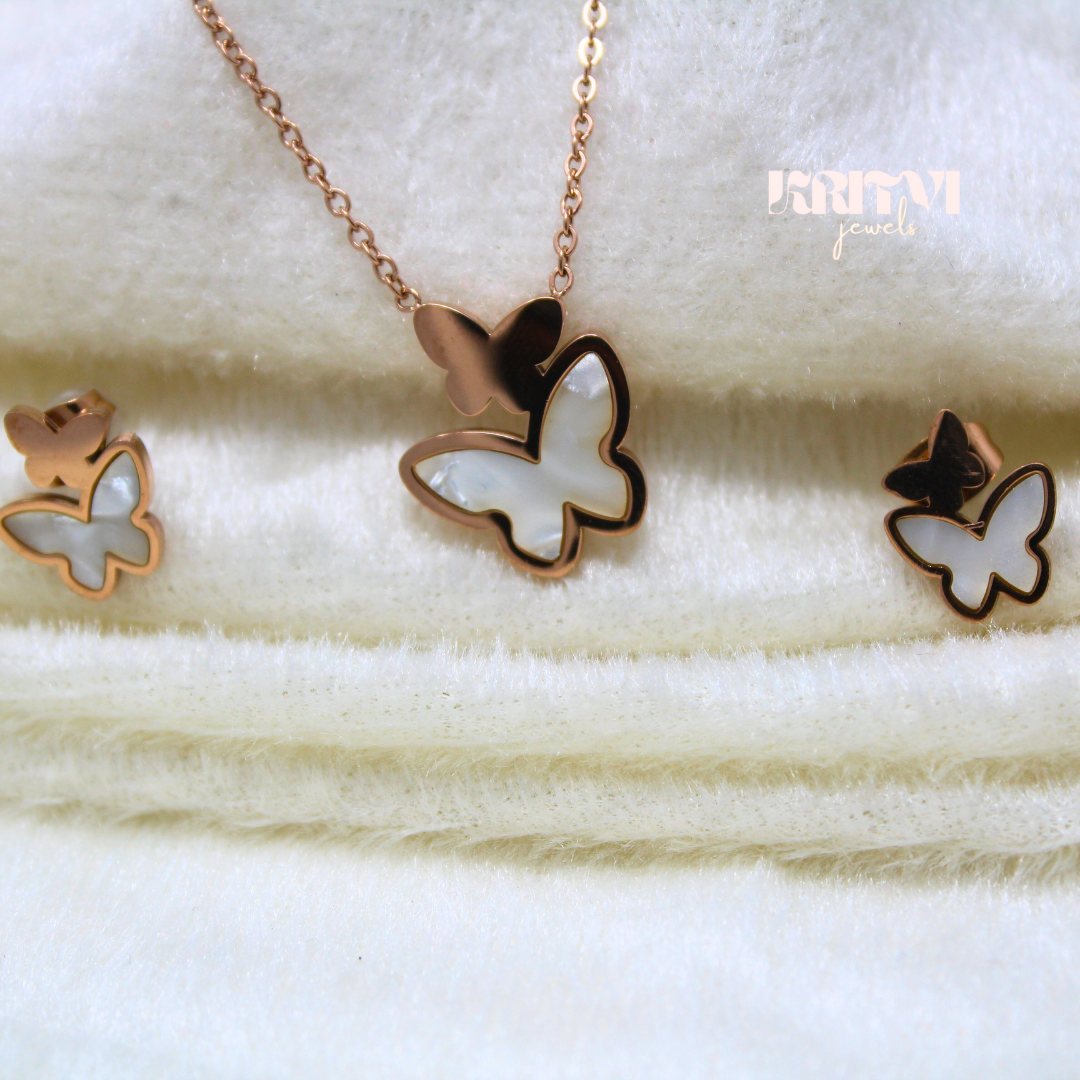 Rose gold-toned necklace featuring a butterfly pendant with a white inlay on one of the butterfly's wings - Image 2