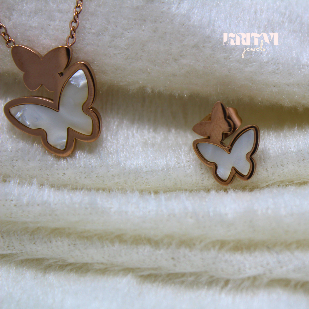 Rose gold-toned necklace featuring a butterfly pendant with a white inlay on one of the butterfly's wings - Image 4